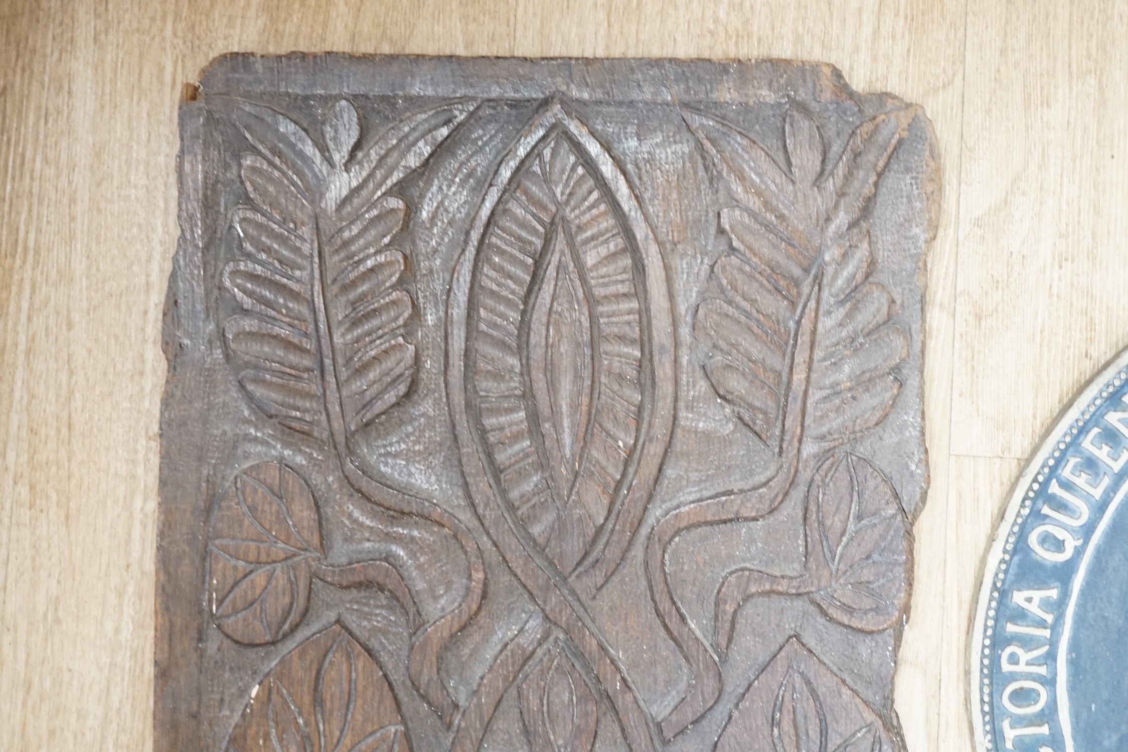 An 18th century carved oak panel together with a commemorative rounded ‘presented by the British and foreign school society to Florence Edith May, pupil in Stockwell College Practicing School to commemorate the completio